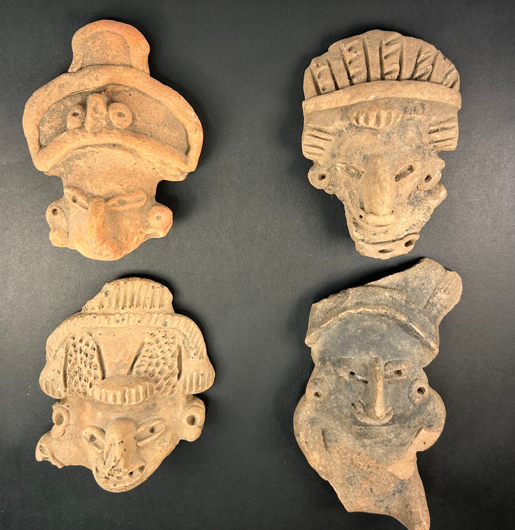 Pre-Columbian terracotta masks, framed group of four with headdress details