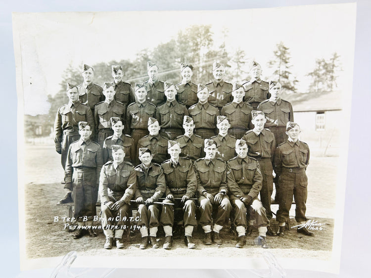 Vintage World War I soldier memorabilia: compass, spent shell, and sepia photograph of troops