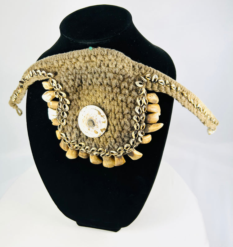 Papua New Guinea ceremonial ornament, cowrie shell center, pierced animal teeth fringe, black stand display