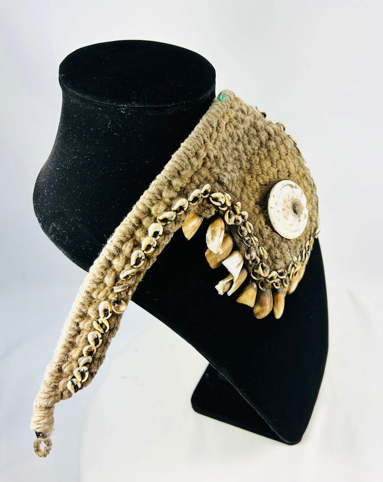 Antique Melanesian ceremonial ornament with cowrie shell center and pierced animal teeth fringe