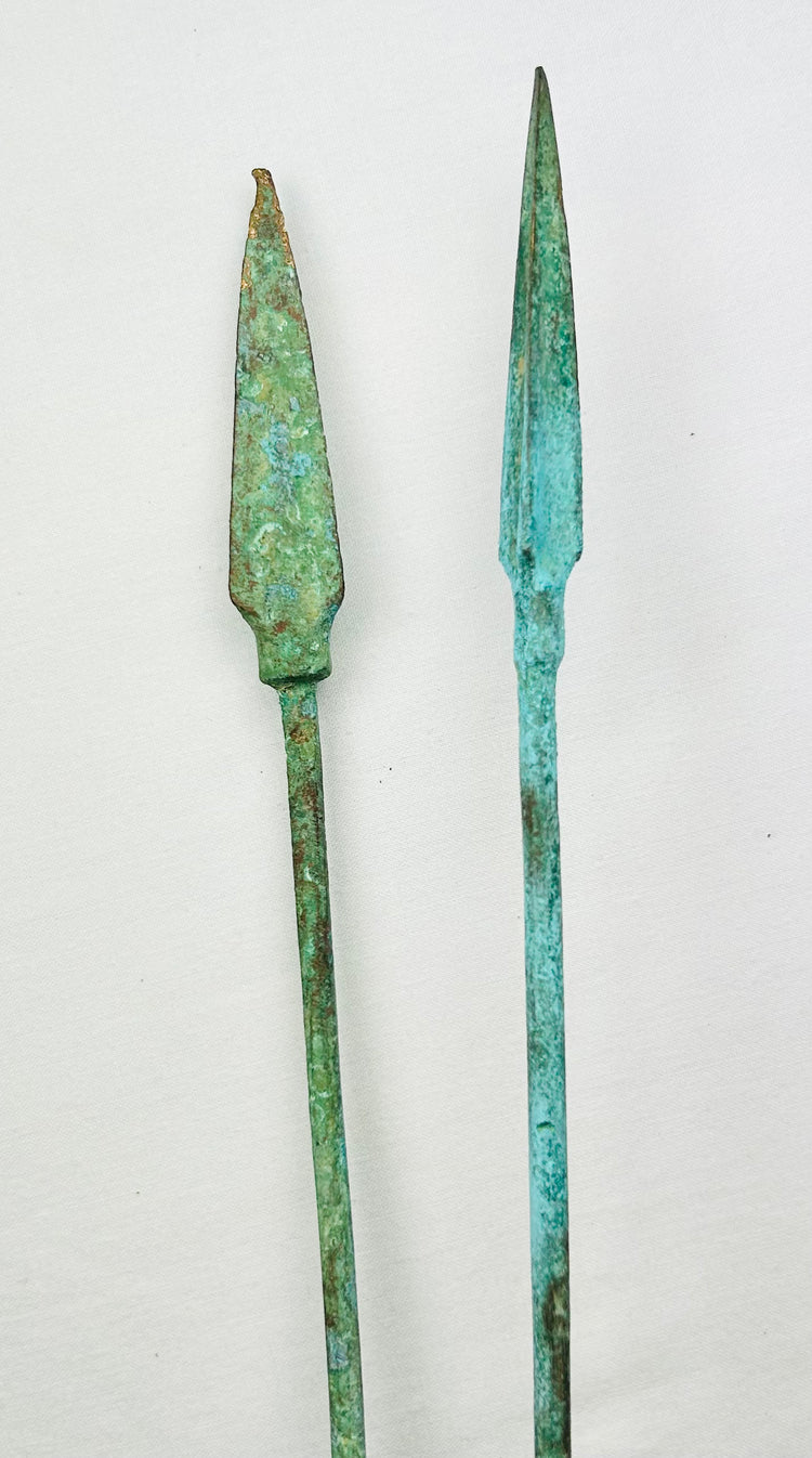 Antique bronze spearheads with tapered blades and natural green patina