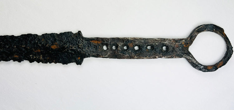 Medieval European dagger with corroded steel blade and circular ring pommel — 14th-century artifact displayed on white background.