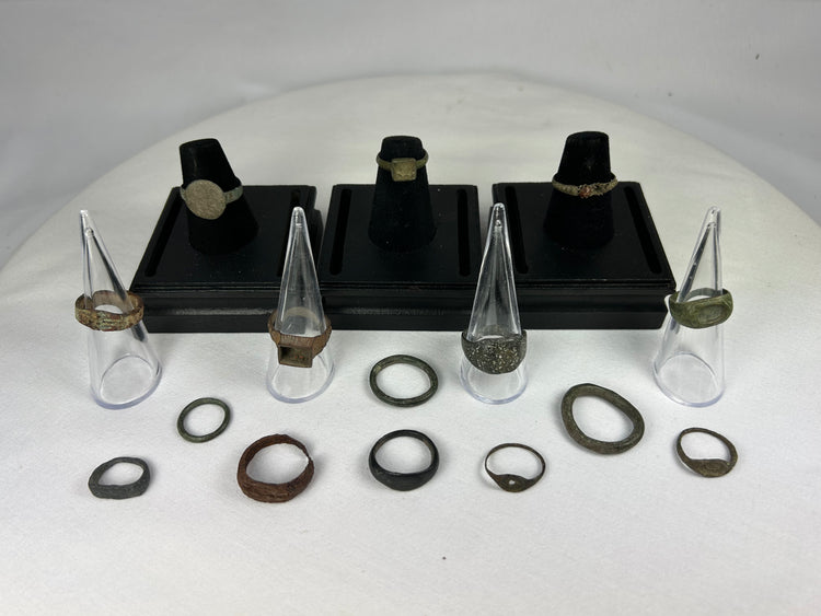 Multi-era bronze ring collection featuring signet, wedding, and ceremonial styles