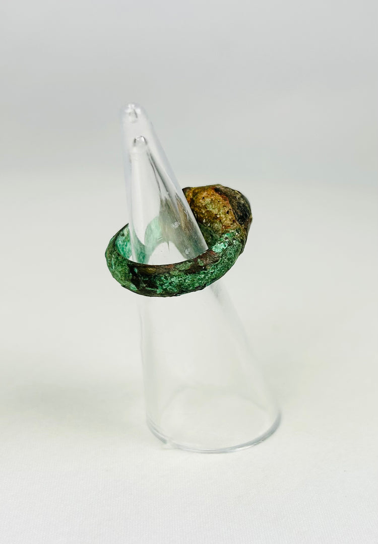 Assyrian bronze ring with deep red gemstone and aged green patina