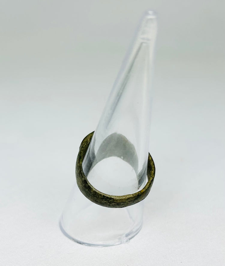 Top view of ancient Roman bronze ring, showing circular bezel and engraved Christogram, 1st–4th Century CE, early Christian artifact.