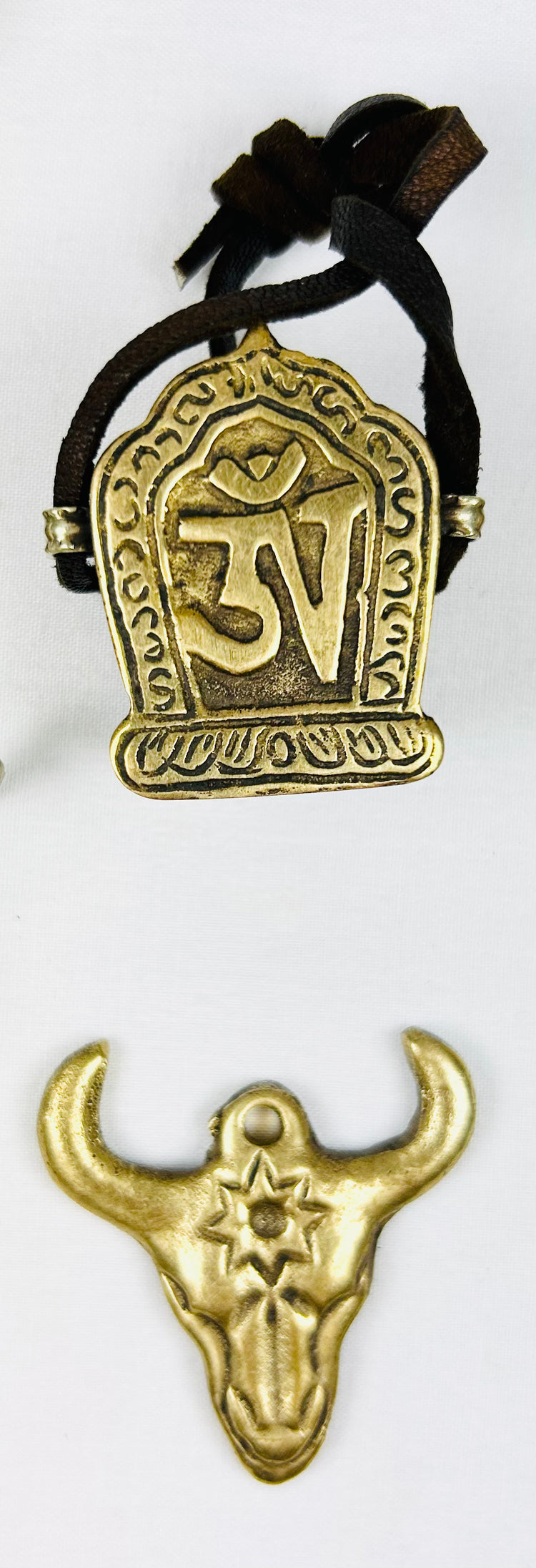 Tibetan amulet collection with St. George, Om Mani Padme Hum, and bull head