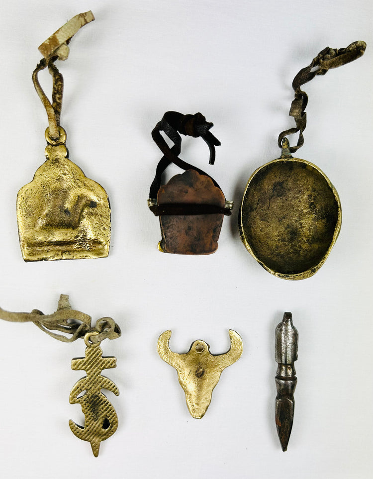 Tibetan amulet set featuring St. George, Om Mani Padme Hum, and mask
