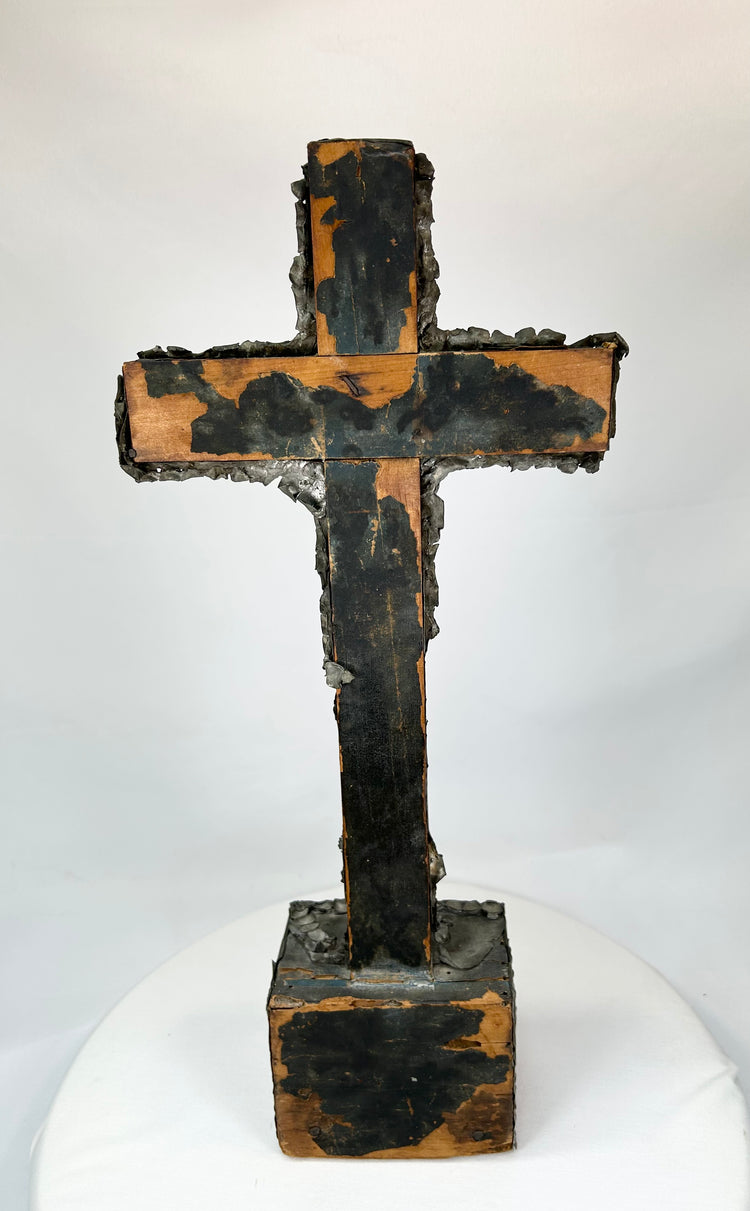 Antique crucifix — angled rear perspective with visible oxidation and wear.