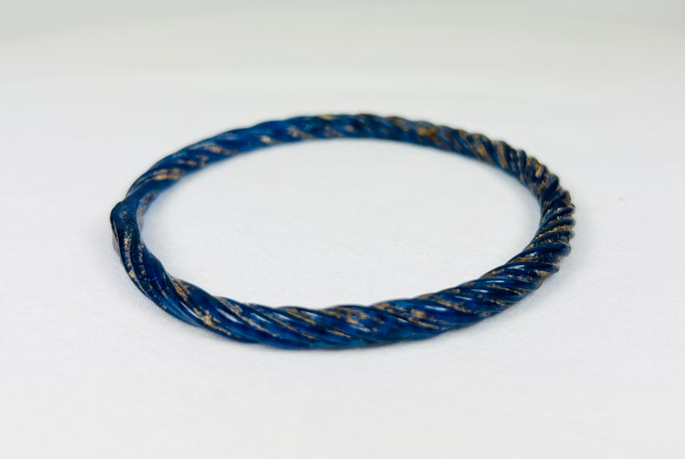 Roman glass bracelet showing twisted pattern symbolizing unity and eternity, 1st–4th century AD.