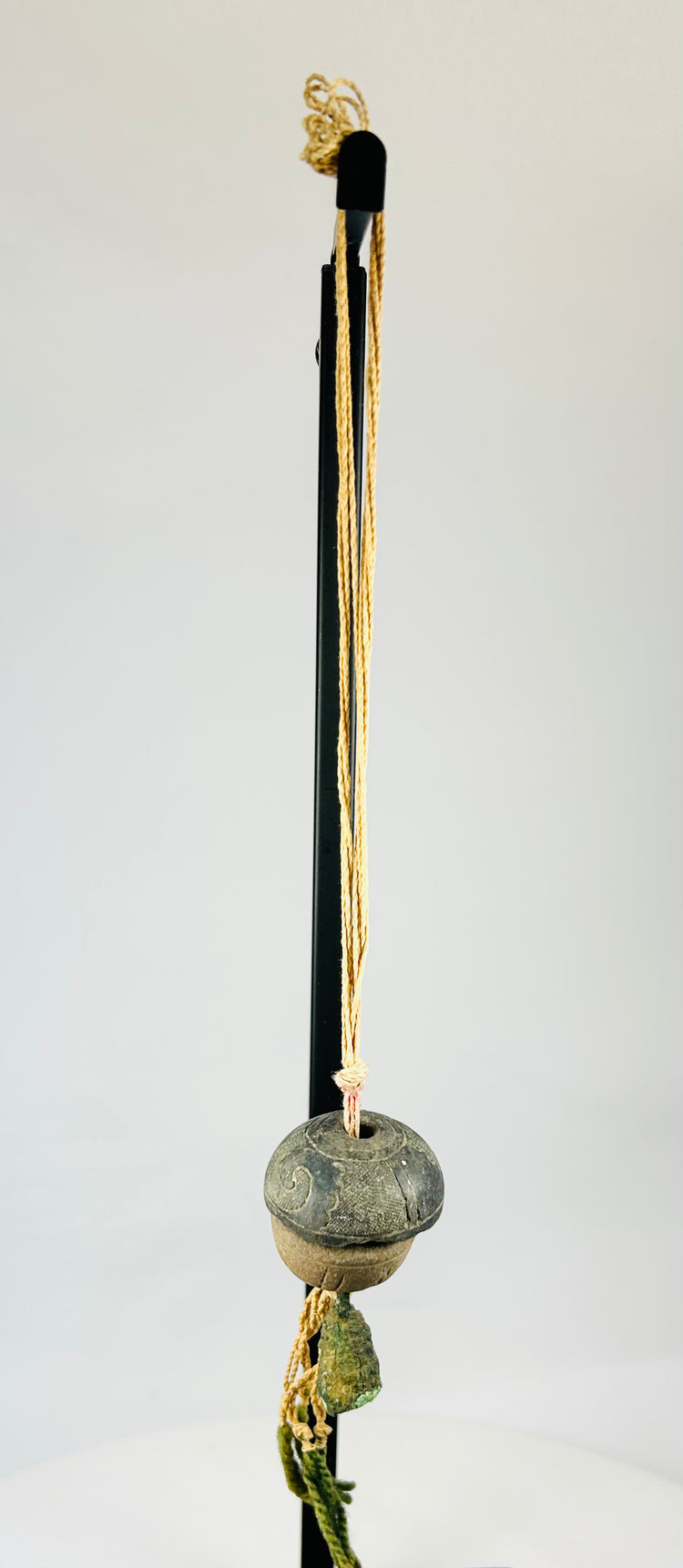 Detailed upper section showing twisted cord attachment and aged fiber condition