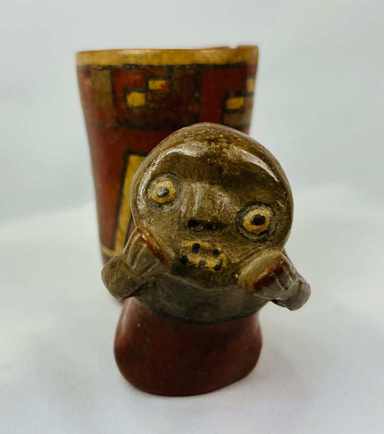 Front view of Pre-Columbian effigy cup showing expressive modeled face and ochre slip surface