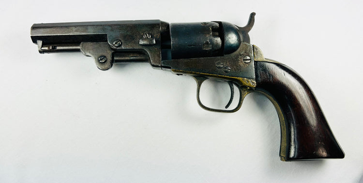 Mid-1800s Colt 1849 Pocket Revolver with engraved cylinder, octagonal barrel, brass trigger guard, walnut grip