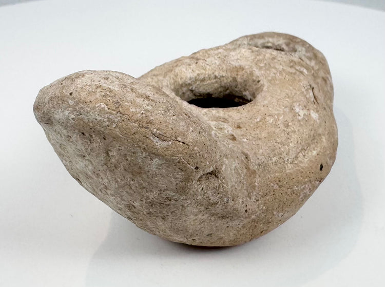 Historic Mediterranean oil lamp showing encrustation and age-related wear