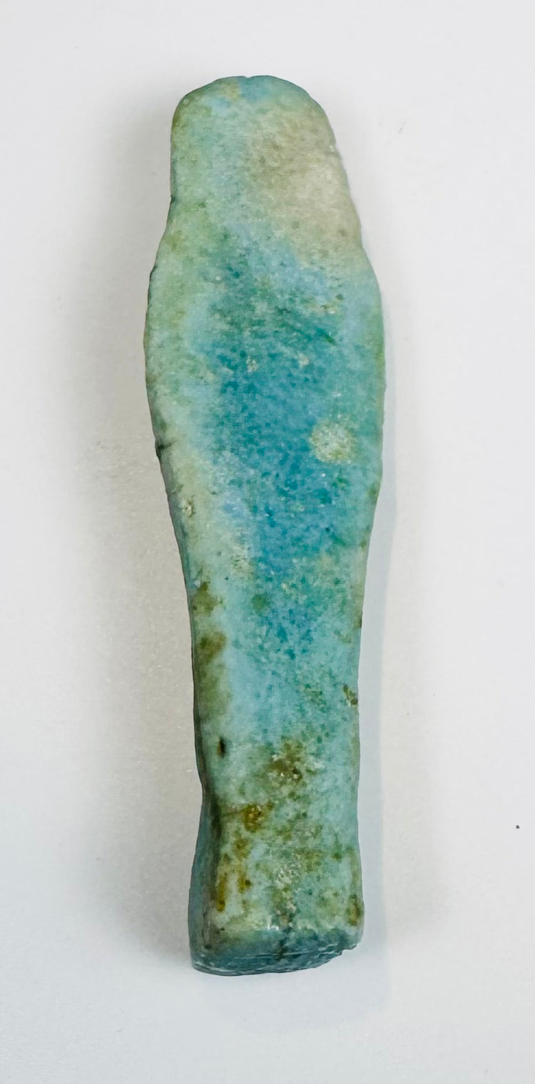 Egyptian funerary servant figure with weathered blue-green glaze