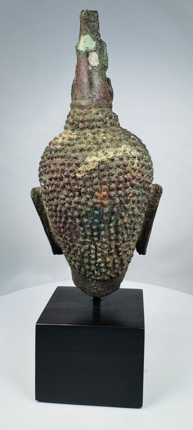 Ancient Thai Buddhist bronze sculpture with brown, red and green patination