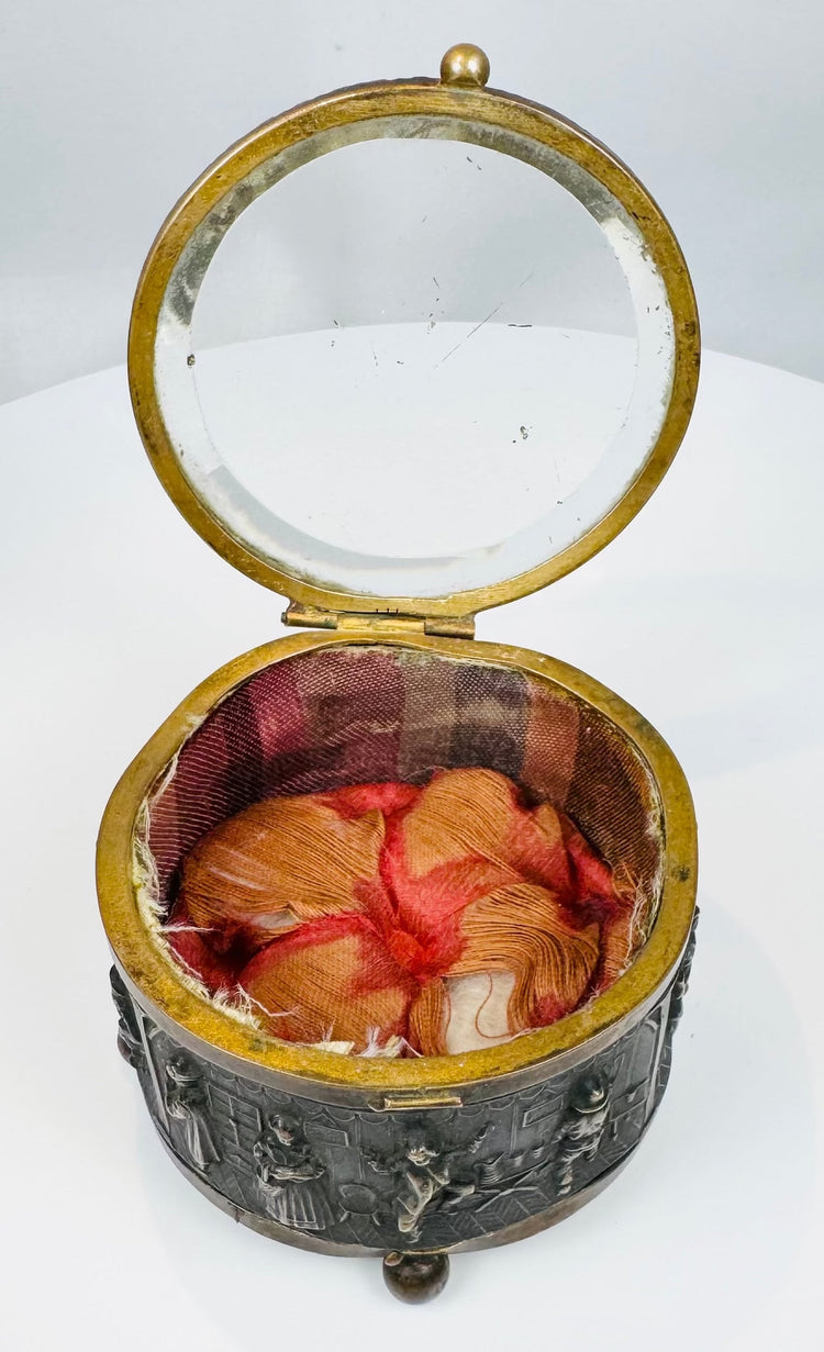 Antique circular jewelry box featuring a thick beveled glass lid