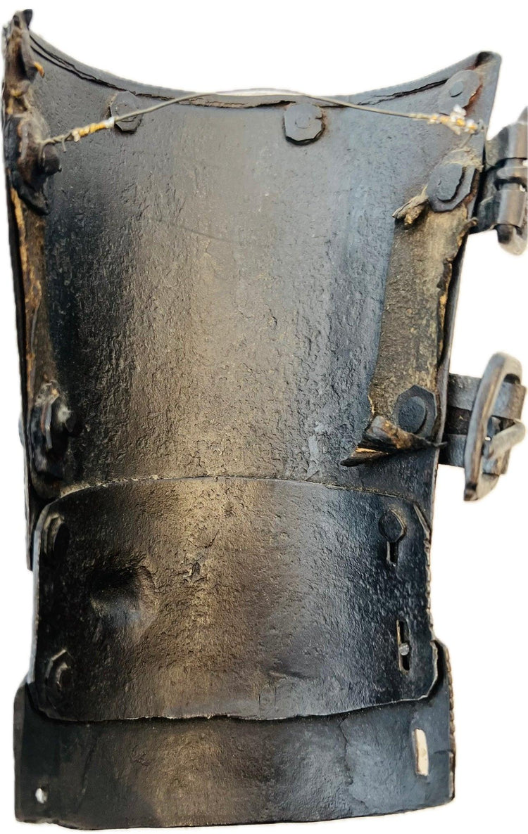 Underside of Medieval continental steel vambrace with aged leather straps and buckles, 15th–16th century.