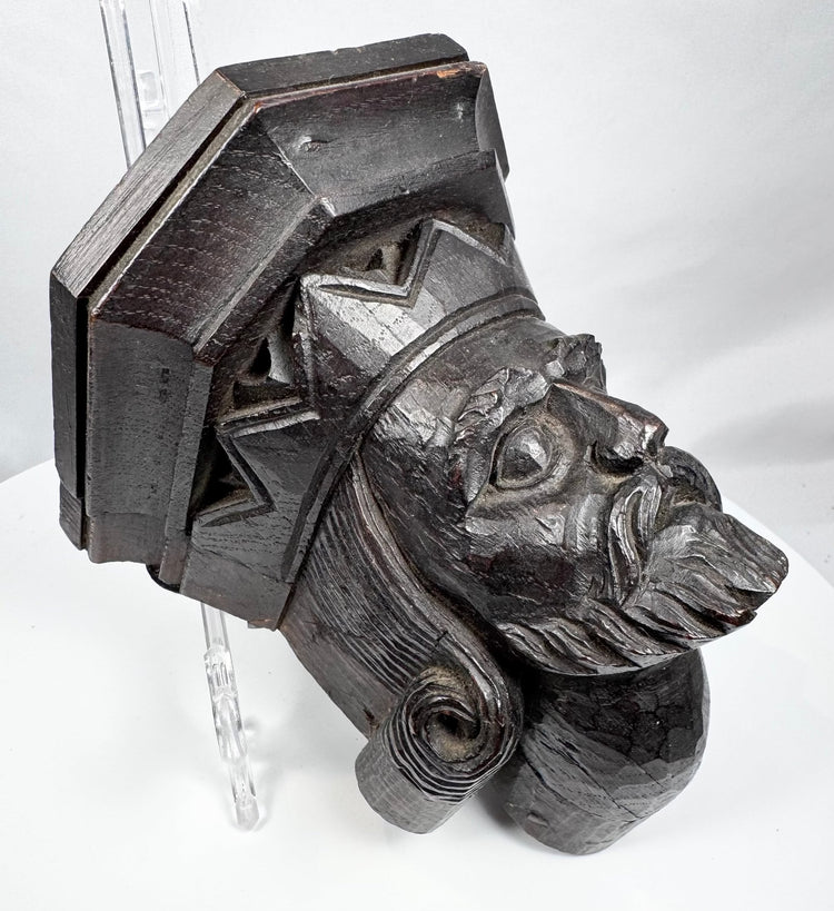 Antique carved wood bracket depicting a medieval-style ruler