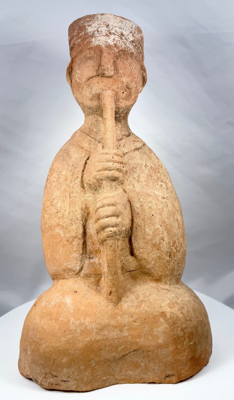 Han Dynasty terracotta musician playing a long wind instrument