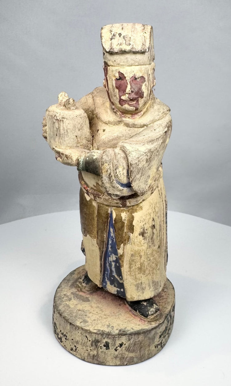 Aged Chinese temple figure with flaking cream and red pigment