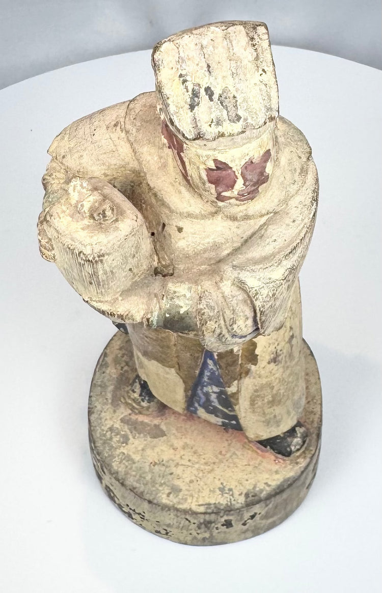 Underside of a hand-carved Chinese wooden attendant figure
