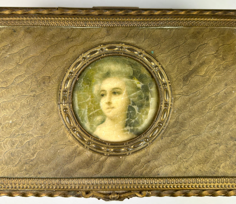 Textured gold sheet with wavy engraved patterns displayed against a white background.