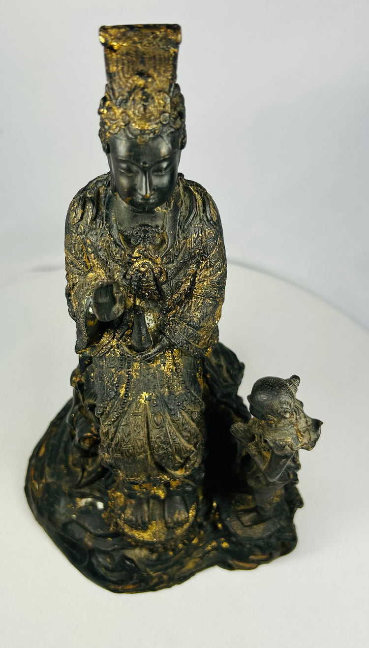 Close-up of Guanyin’s face on Thai bronze statue, showing serene expression and remnants of original gilding.