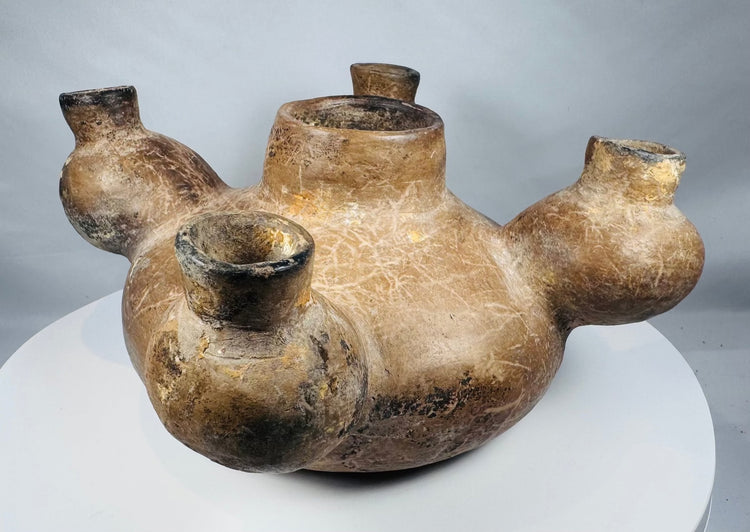 Underside of an ancient Colima vessel showing cracks and mineral deposits