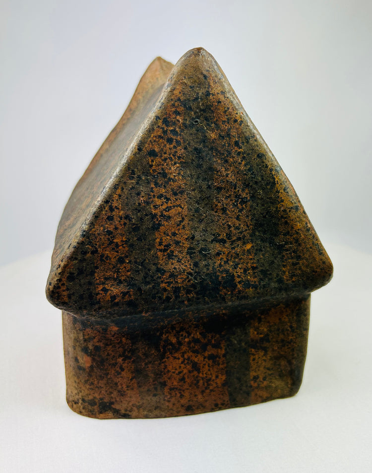 Side view of terracotta house model from West Mexico with ribbed roof texture.