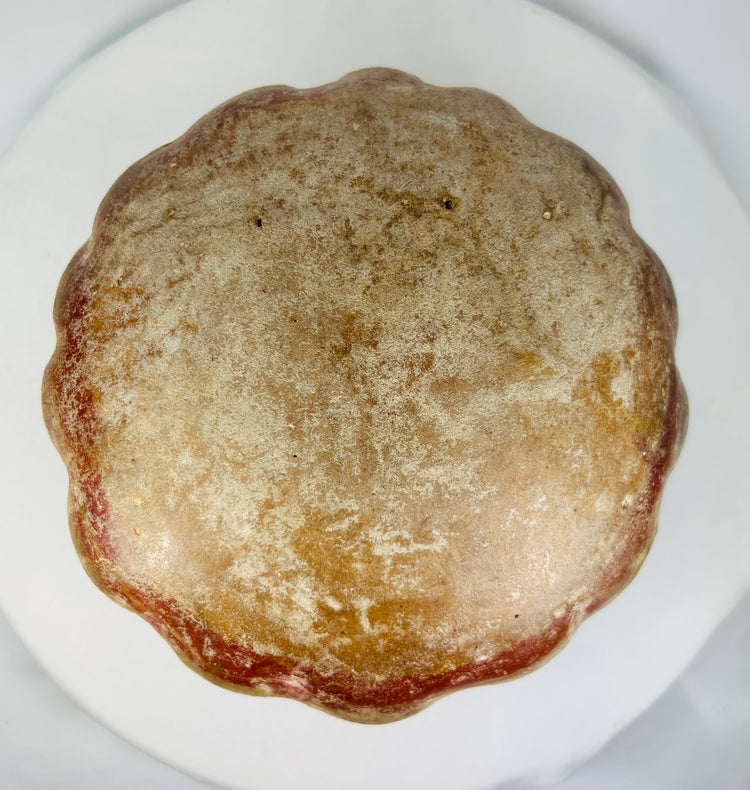 Bottom view of Pre-Columbian ceramic vessel showing textured base and natural wear.