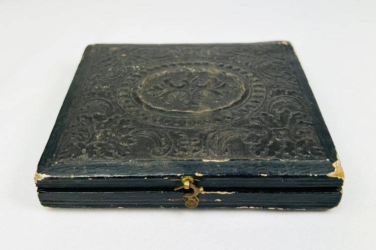 Civil War–era black leather photographic case with gold clasp, closed view