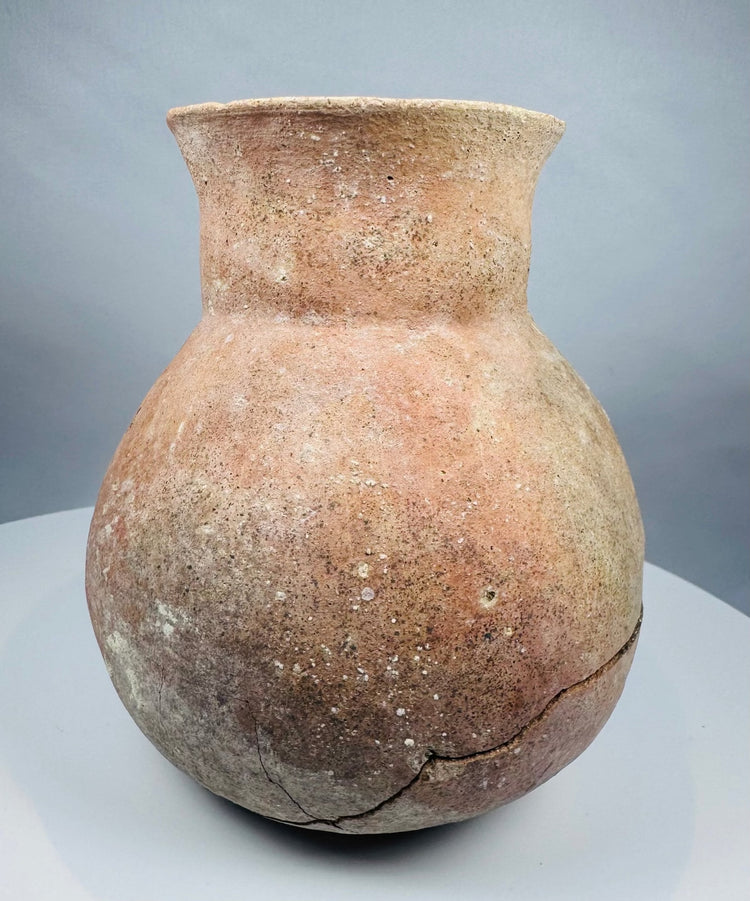 Pre-Columbian earthenware jar displaying archaeological deposits and an aged surface