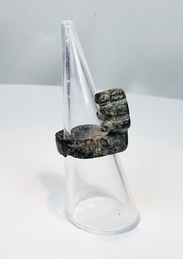 Side profile of an ancient Roman bronze ring key showing its raised shaft and multiple key teeth