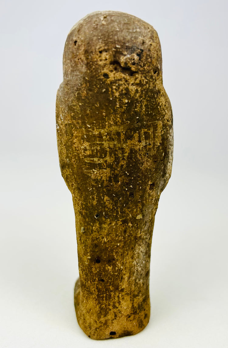 Rear view of a sandstone ushabti showing age patina and surface wear.