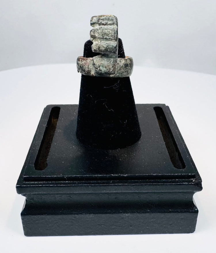 Ancient Roman ring key showing the weathered bronze surface and softened details produced by burial