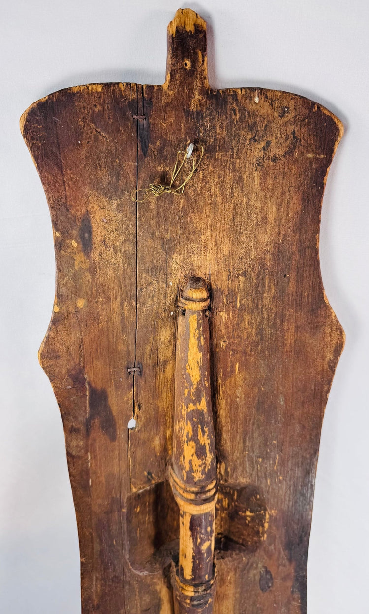 Close-up of the shield’s aged wood, incised ornamentation, and surviving white pigment