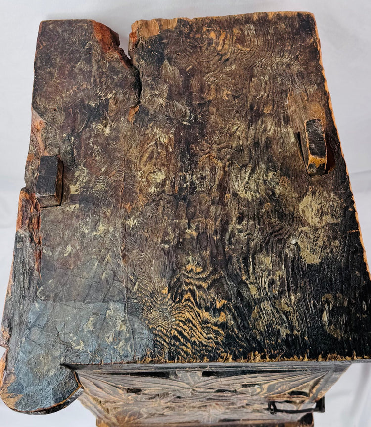 Hand-carved floral and foliate panel on an antique South Asian chest