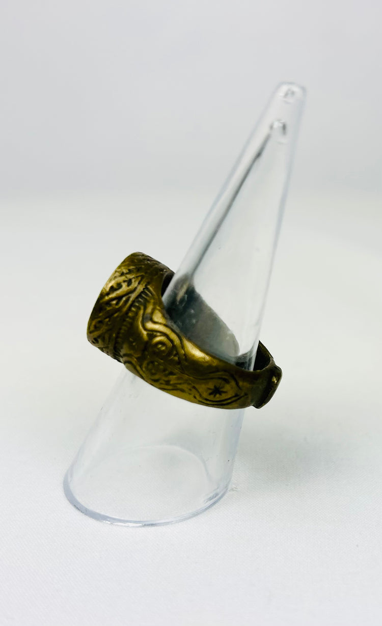 Bronze Roman-era ring displayed on a white surface with detailed carvings