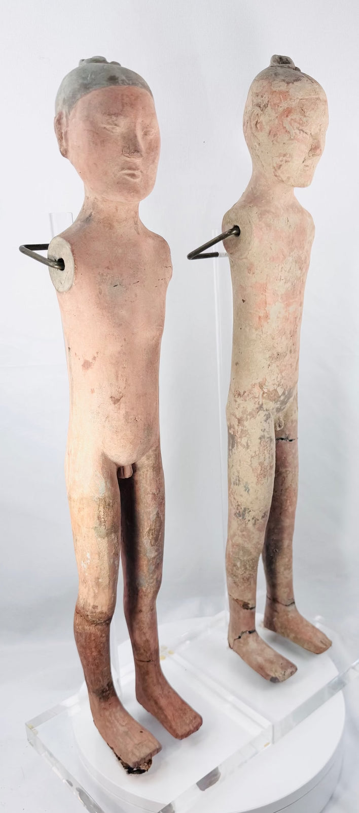 Detailed facial features and raised topknot on an ancient Chinese tomb figure
