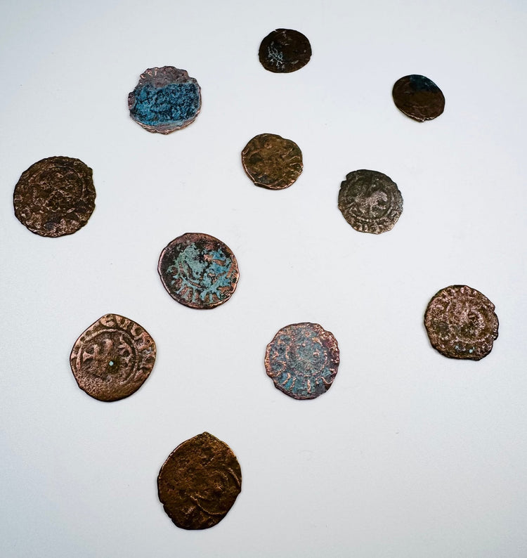 Medieval bronze coins displaying Christian crosses and remnants of period inscriptions