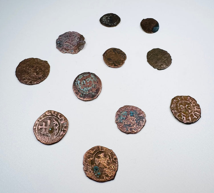 Eleven historic Levantine coins showing varied sizes, shapes, and struck designs