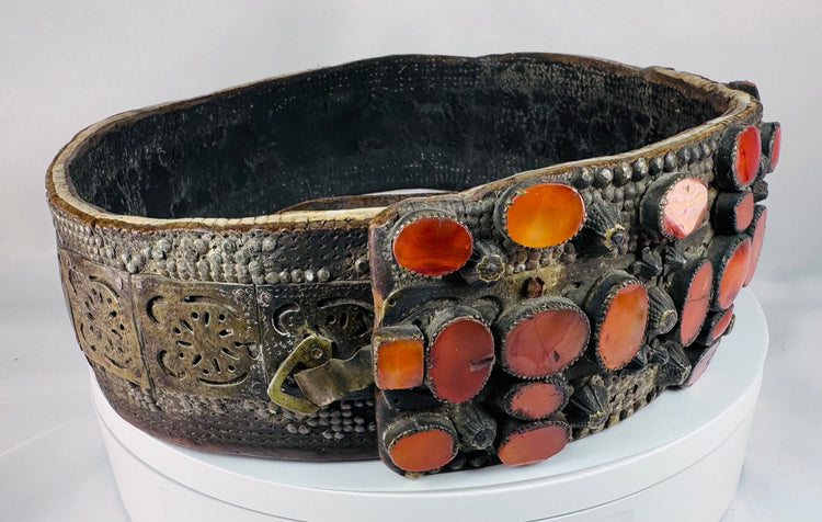 Detailed view of the pierced brass plates and riveted fittings on a historic Jewish wedding belt from Eastern Europe.