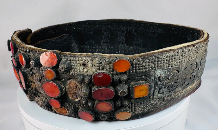 Close-up of orange Cornelian gemstones set into an ornate Jewish bridal belt dating to the 17th–18th century.