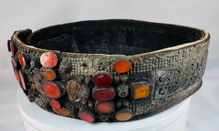 Close-up of orange Cornelian gemstones set into an ornate Jewish bridal belt dating to the 17th–18th century.
