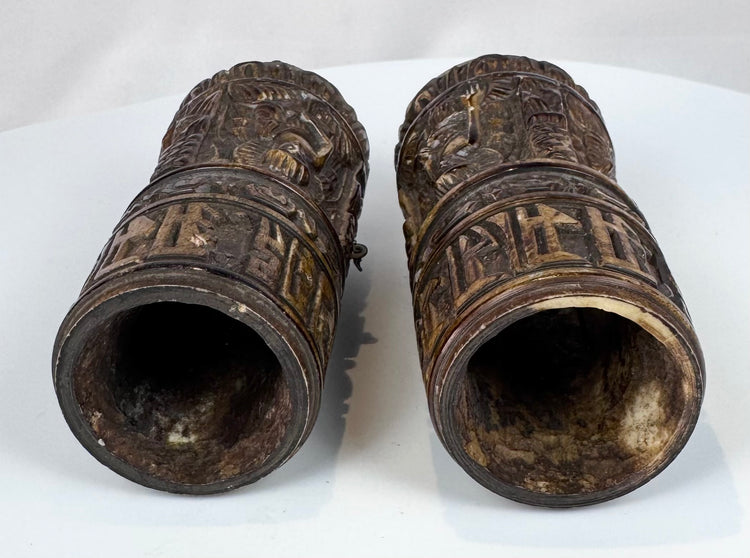 Rare pair of Tibetan Buddhist human bone prayer wheels with carved Buddha figures, sacred inscriptions, and centuries-old surface wear.