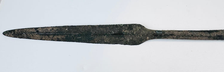 Ancient bronze spearhead from Cyprus featuring a tapered blade, reinforced four-sided midsection, preserved tang, and naturally oxidized surface from the Early Cypriot III period.