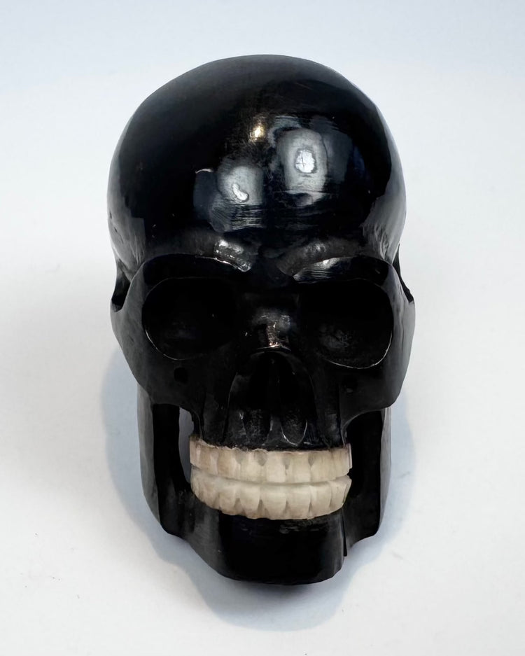 Miniature polished black horn skull carving, circa 1880–1950