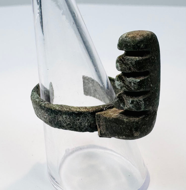 Front view of an ancient Roman ring key with stepped locking teeth and mineral deposits