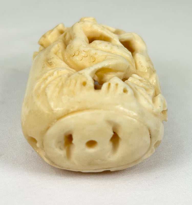 Elegant Japanese decorative bone ornament with pierced bird and plant design, early 20th century