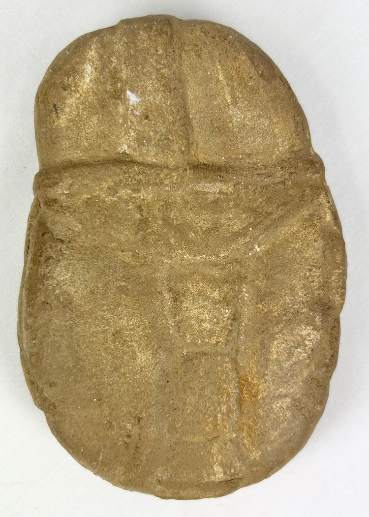 Boldly carved stone face effigy with warrior symbolism and patina